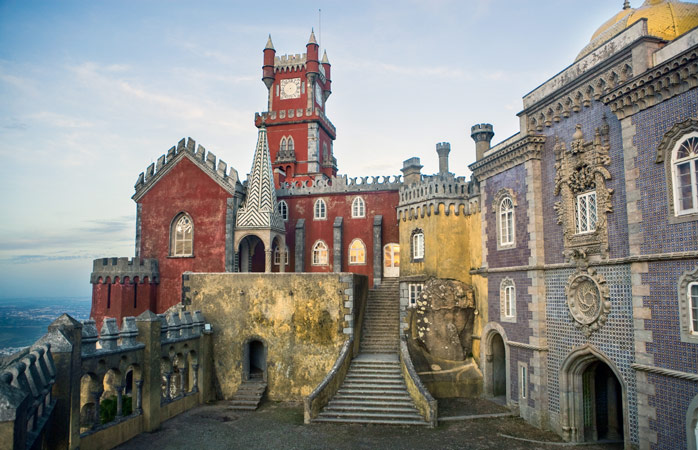 Visit the enchanting Pena Palace perched atop a lush hill in Sintra