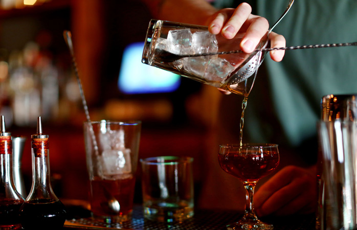 A bartender serves up some fine whisky cocktails