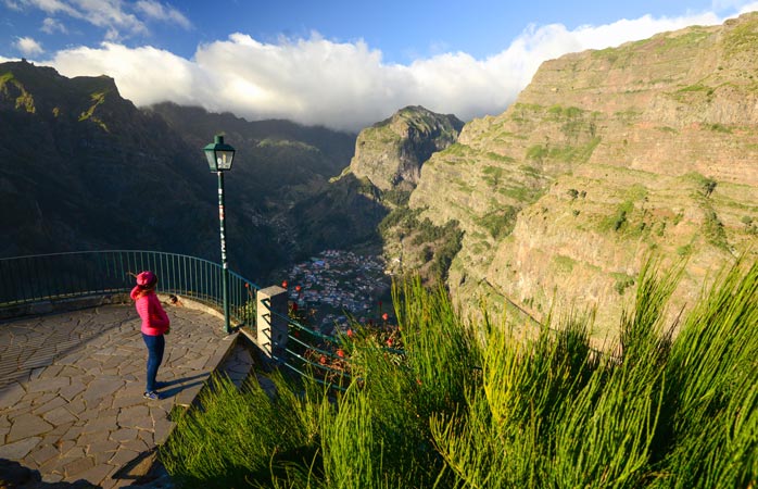 A woman admires the view of Madeira Island from a viewpoint 