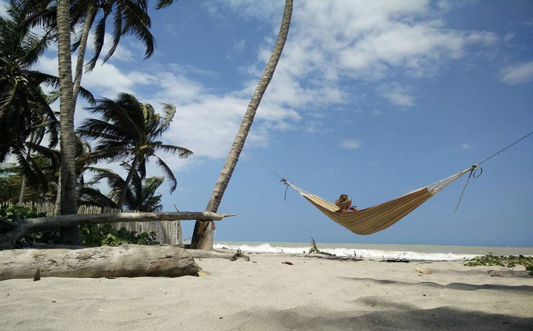 Peaceful beach vibes and a bohemian community of travellers await you at Palomi Beach in Colombia