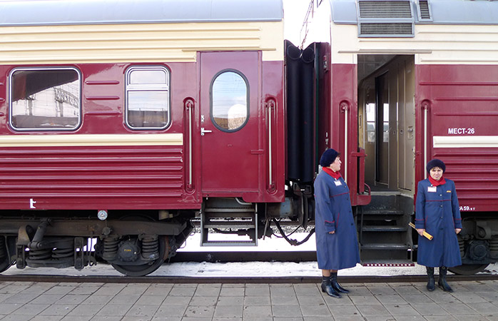Provodnitsas - train attendants in front of the Trans-Siberian train